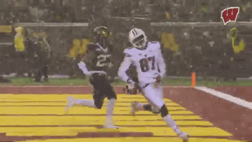 Football Player Number 87 Running Toward Player