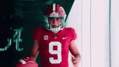 Football Player Number 9 Holding Football