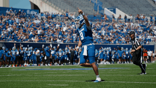 Football Player Number 9 Standing on Field