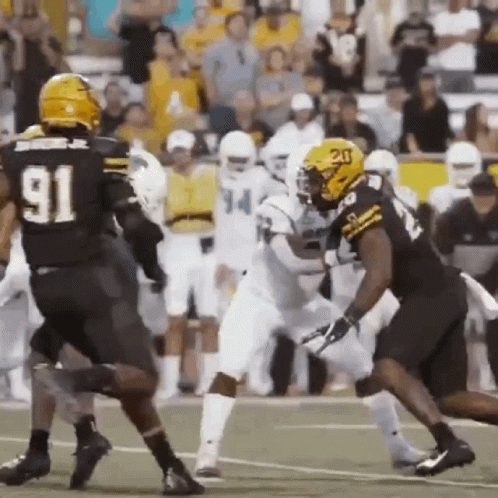 Football Player Number 91 Being Tackled