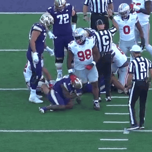 Football Player Number 98 Being Tackled