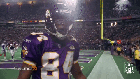 Football Player Randy Moss Showing Off Muscles GIF