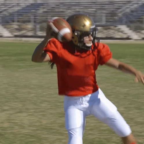 Football Player Red Shirt White Shorts Throwing
