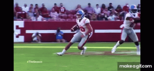 Football Player Running Ball with Tackler