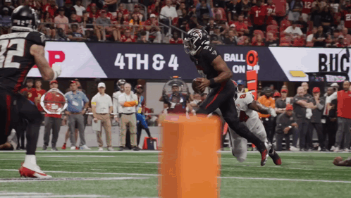 Football Player Running With Ball Before 4Th And 4 Sign GIF