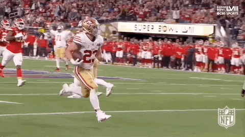 Football Player Running With Ball During Super Bowl