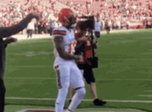 Football Player Running With Cameraman