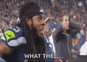 Football Player Sitting in Stands Saying What The