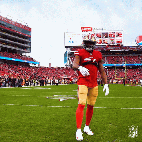 Football Player Standing In Front Of Levi's Sign GIF