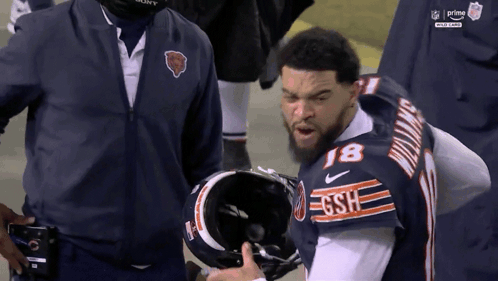 Football Player Stands On Field Saying That Playful GIF