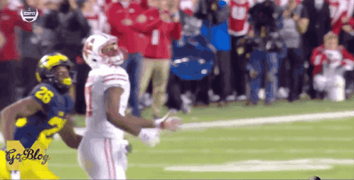 Football Player Tackled by Yellow Uniform