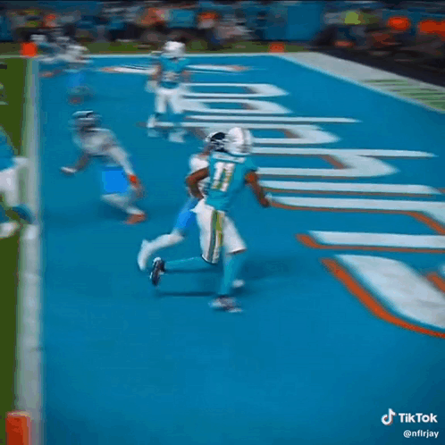 Football Player Trying to Catch Pass