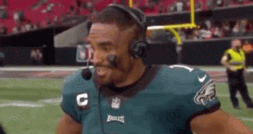 Football Player With Headphones and Headset Talking