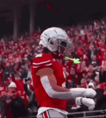Football Player With Helmet and Gloves Hands in Air