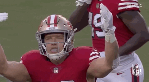 Football Player With Helmet and Gloves Hands Up