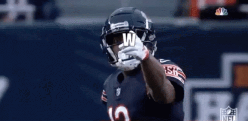 Football Player With Helmet and Letter W on Hand