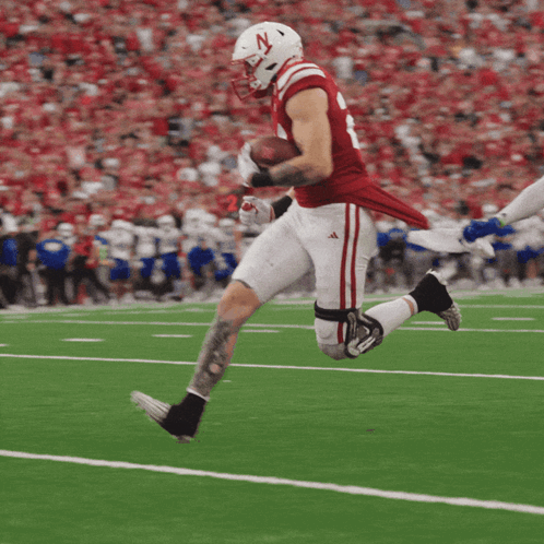 Football Player With N Helmet Running With Ball
