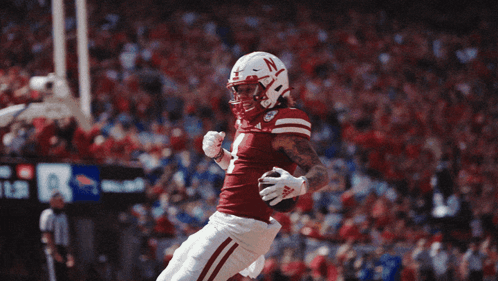 Football Player With N on Helmet Jumping