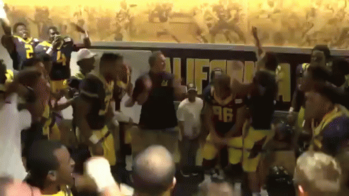Football Players Dancing in Front of California Sign