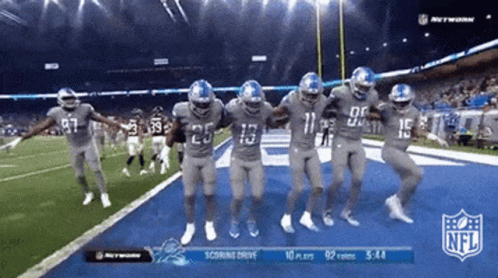 Football Players Dancing In Front Of NFL Scoreboard GIF