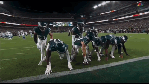 Football Players Getting Ready to Run