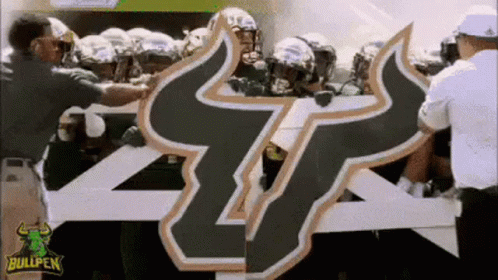 Football Players Holding Bullpen Sign GIF