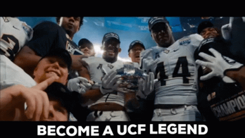 Football Players Holding Trophy Become A UCF Legend