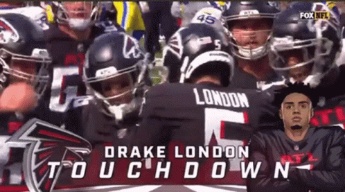 Football Players Huddled with Drake London