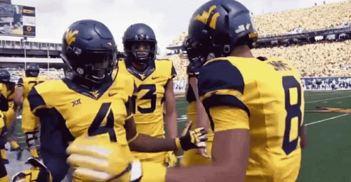 Football Players Hugging Number 4
