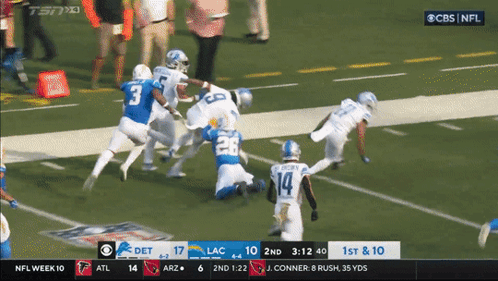 Football Players Hugging on Field