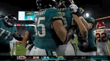 Football Players Hugging on Field
