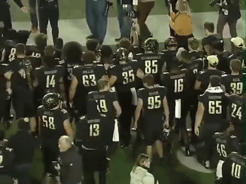 Football Players in Black Jersey Number 13
