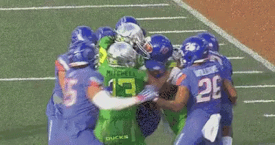 Football Players in Blue Uniforms With Number 55