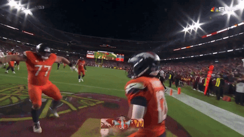 Football Players In Helmets Standing Together GIF