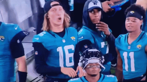Football Players in Jerseys Number 16 and 11