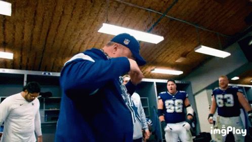 Football Players in Locker Room Number 63