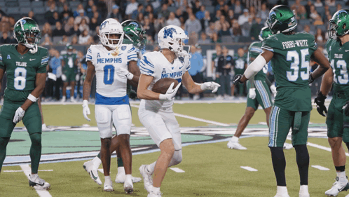 Football Players in Memphis Uniforms on Field