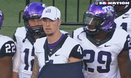 Football Players in Purple and White Uniforms Number 29