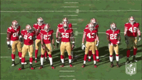 Football Players in Red and Gold Uniforms Number 56