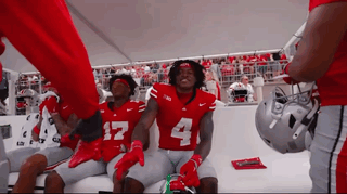 Football Players in Red Jerseys Number 4