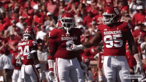 Football Players in Red Jerseys Sooners