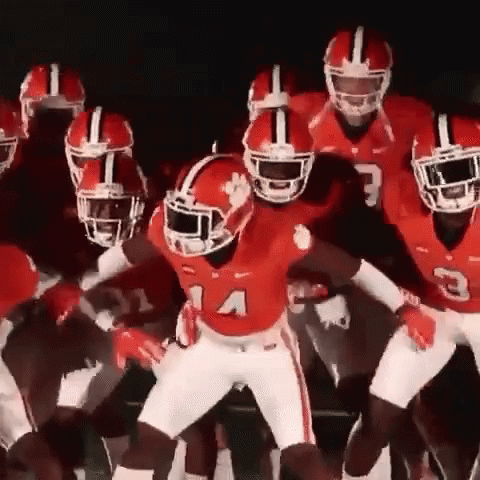 Football Players in Red Uniforms Dancing Together