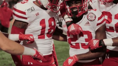 Football Players in Red White Uniforms With Adidas Gloves