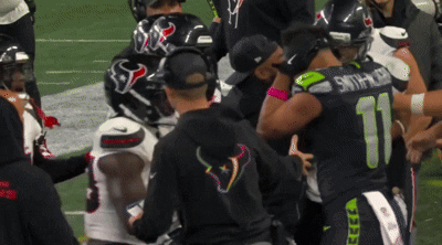 Football Players Including Number 11 Huddled Together