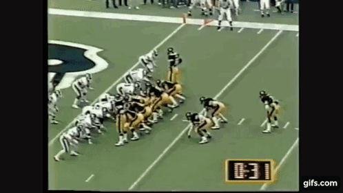 Football Players Lined Up on Field With Clock Showing 10:31