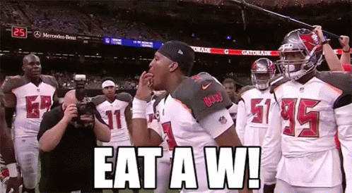 Football Players on Field Saying Eat a W