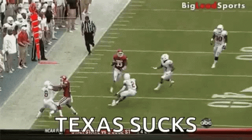 Football Players on Field Saying Texas Sucks