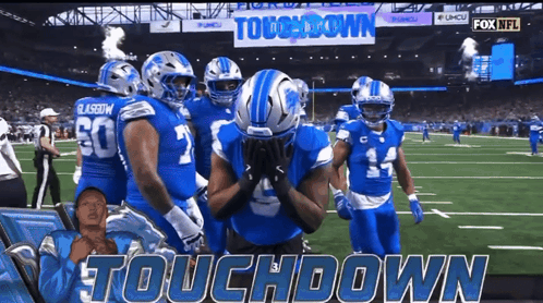 Football Players on Field Saying Touchdown