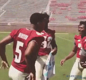 Football Players on Field With Number 5 Jersey