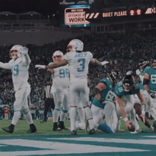 Football Players on Field With Quiet Please Sign